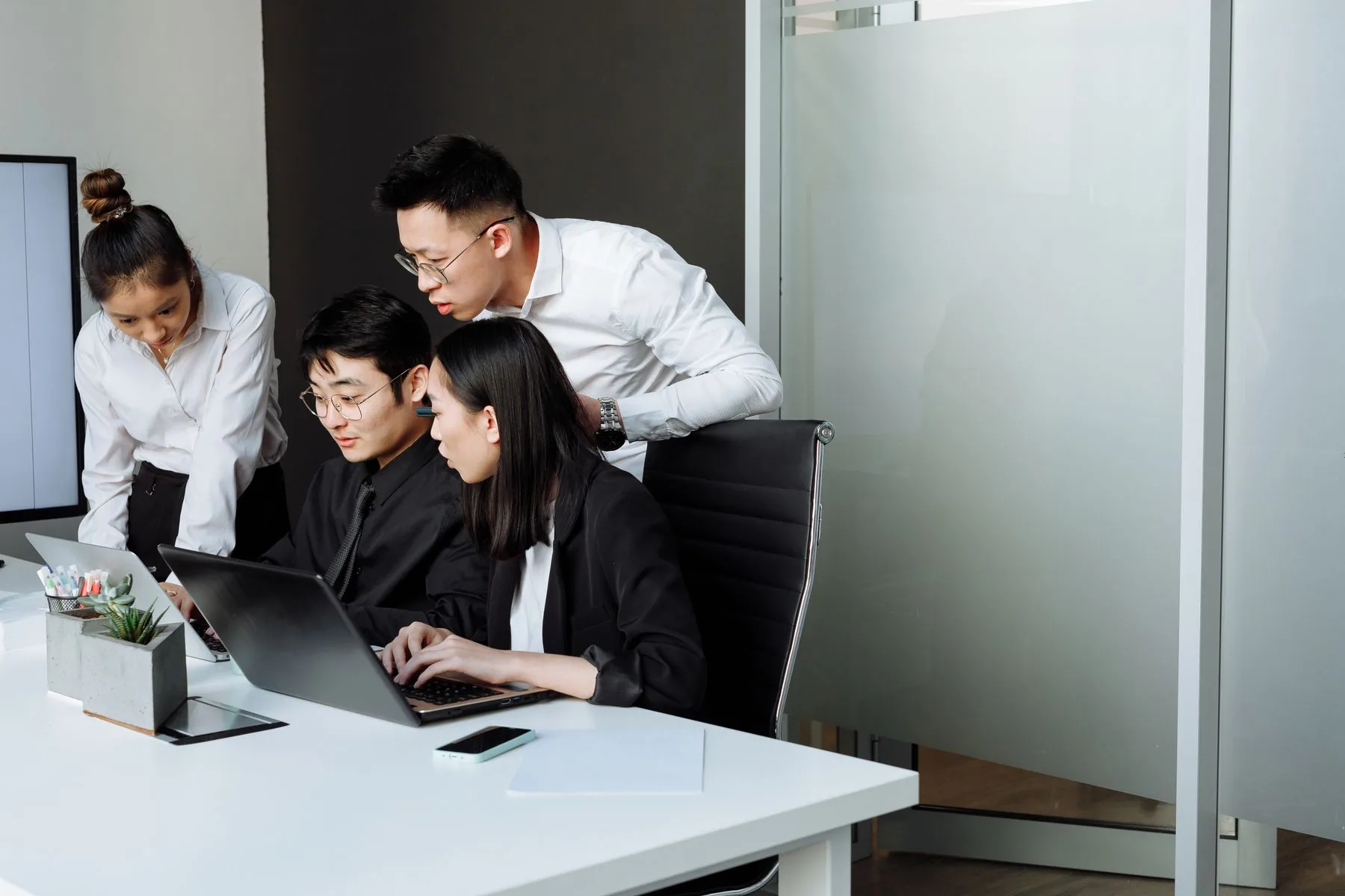 Colleagues collaborating around an office table